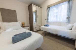 a bedroom with two beds and a window at Quayside in Christchurch +44 photos