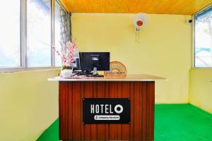 an office with a desk with a hotel sign on it at Super Hotel O Chilapata Forest Formerly Moner Manush Homestay in Uttar Simlabari