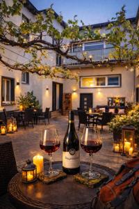 a bottle of wine sitting on a table with two glasses at Ahr Apart in Dernau