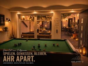 a pool table with balls on it in a room at Ahr Apart in Dernau