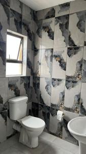a bathroom with a toilet and a sink at Spadade View in Roodepoort