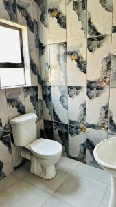 a bathroom with a toilet and a sink at Spadade View in Roodepoort