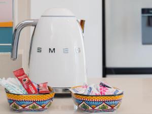 a kitchen counter with two baskets of toothbrushes and a mixer at Alwil Apartment 11 in Struisbaai