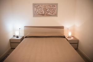 a bedroom with a bed with two nightstands at Suite Prestige Apartment in Torri del Benaco