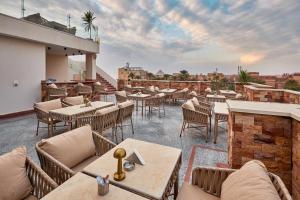 a restaurant with tables and chairs on a roof at Palmeras Pyramids Hotel in Cairo