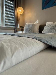 a large white bed in a room with a window at Ahr Apart in Dernau