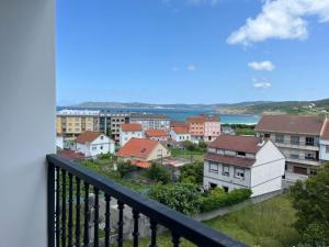 a view of a city from a balcony at Apartamentos Vive Laxe in Laxe +74 photos