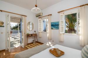 a bedroom with a bed and a view of the ocean at Alegria Villa in Pollonia