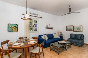 a living room with a table and a blue couch at Alegria Villa in Pollonia
