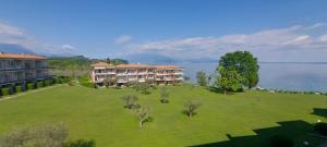 an aerial view of a resort with a large lawn at Florence Garda Hotel in Manerba del Garda