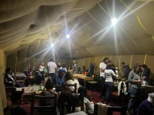 a group of people sitting in a tent at Sahara Standard Camp in Merzouga