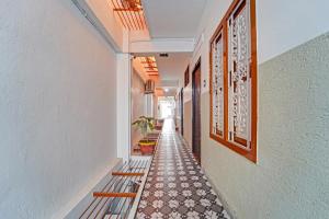 an empty hallway with benches and paintings on the walls at Super Hotel O Erode Bus Stand in Erode