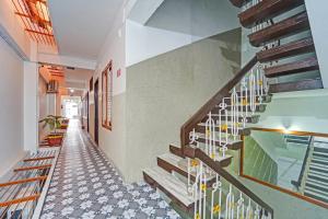 a hallway of a house with a staircase at Super Hotel O Erode Bus Stand in Erode +37 photos