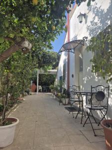 a patio with tables and chairs next to a building at Drin room in Catanzaro Lido