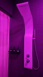 a purple bathroom with a shower with a claw footatural at Luana SPA Boussois in Boussois