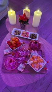 a table topped with plates of food and candles at Luana SPA Boussois in Boussois +14 photos