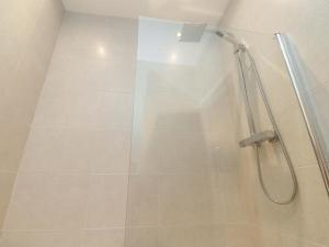 a shower with a glass door in a bathroom at Flat 2, Dorstan in Carnforth +15 photos