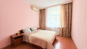 a bedroom with a bed and a window at Pavlovskaya square in Kharkiv