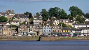 a group of houses on a hill next to the water at Flat 2, Dorstan in Carnforth