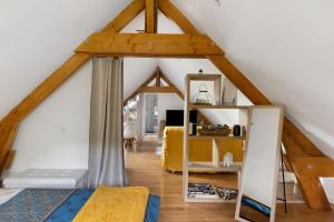 a bedroom with a bed and a room with white walls at La Lizardiere des Landes in La Flèche