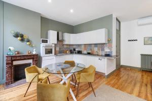 a kitchen with a glass table and chairs at Trois Clés Apartment 2 - 2 bed in Eymet +14 photos