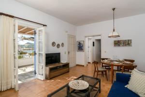 a living room with a blue couch and a table at Alegria Villa in Pollonia