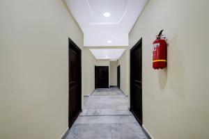 a hallway with a fire extinguisher on the wall at Super Collection O Kothapet Near Omini Hospital in Upal