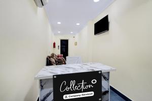 a white room with a counter with a sign on it at Super Collection O Kothapet Near Omini Hospital in Upal