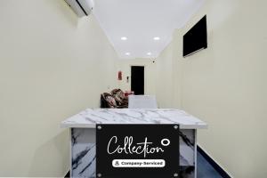 a table with a sign on it in a room at Super Collection O Kothapet Near Omini Hospital in Upal +37 photos