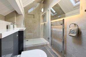 a bathroom with a shower and a toilet and a sink at 4 Bed in Wadebridge oc-p00066 in Little Petherick +24 photos