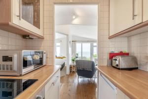 a kitchen with a counter top with a microwave at 2 Bed in Stoke Fleming oc-bc777 in Stoke Fleming