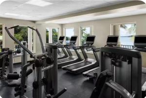 a gym with several rows of cardio machines at Saint Thomas Villa with Ocean view in Frenchmans Reef Heliport