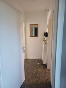 a hallway with a white wall and a picture on the wall at Gästewohnung Illa in Meerbusch