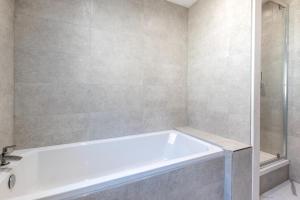a white bath tub in a bathroom with a shower at 1 Bed in Ilfracombe oc-n2052 in Berrynarbor +5 photos