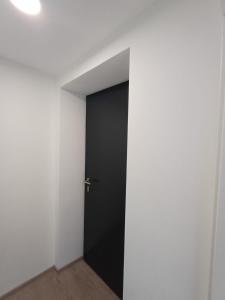 a black door in a room with a white wall at Gästewohnung Illa in Meerbusch +11 photos