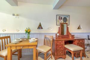 a dining room with a table and a wooden dresser at 1 Bed in Keswick oc-28382 in Braithwaite