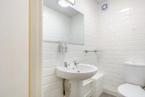 a white bathroom with a sink and a toilet at 1 Bed in Keswick oc-28382 in Braithwaite +8 photos