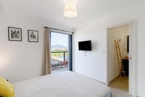 a bedroom with a bed and a sliding glass door at Stagnolo in Porticcio