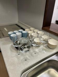 a bunch of wine glasses sitting on top of a counter at Hanako-Home in Fukuoka +22 photos