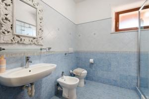 a bathroom with a sink and a toilet and a mirror at Apartment Celeste - Isola D'elba in Portoferraio +23 photos