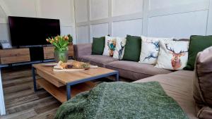 a living room with a couch and a coffee table at LandHaus Hof Wehlenbach in Hallenberg