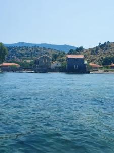 a large body of water with houses in the background at Aura Seaside Apartments in Petra +2 photos