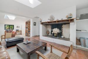 a living room with a table and a fireplace at Gite Les 3 Tilleuls in La Ville Dieu du  Temple