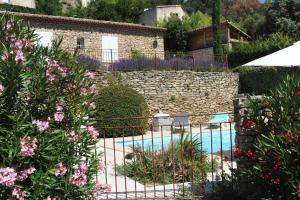 a garden with a swimming pool and flowers at Maison des Cigales a heavenly setting in Saumane-de-Vaucluse
