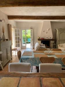 a living room with a table and chairs at Maison des Cigales a heavenly setting in Saumane-de-Vaucluse +38 photos