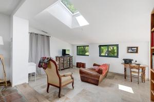 a living room with a couch and a chair at Gite Les 3 Tilleuls in La Ville Dieu du  Temple