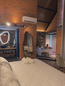 a bedroom with a bed and a bath room with a tub at Guest house Etérea in Flores da Cunha +10 photos