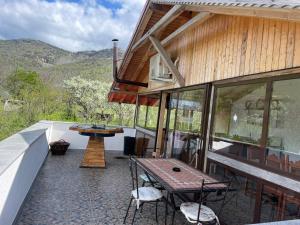 a patio with a table and chairs on a house at Casa Haralambie in Greci