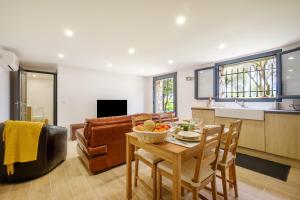 a kitchen and living room with a table and chairs at Villa Cyprès Bleu in Peymeinade