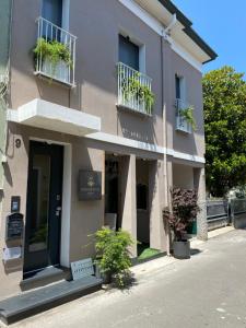 a building with potted plants on the windows at squero 911 appartament in Cesenatico